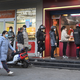 People line up to buy food at a booth in Xian, capital of northwest China’s Shaanxi Province, on Jan. 17, 2022 during the city’s strict lockdown.